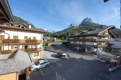 arial view of a town with mountains in the background at Cesa Meida 3 in Pozza di Fassa