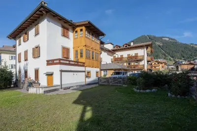a large house in a village with a yard at Cesa Meida 4 in Pozza di Fassa