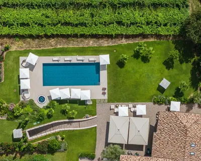 an aerial view of a yard with a swimming pool at Ansitz Battisti Suites in Caldaro