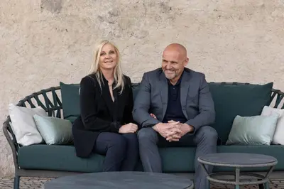 a man and a woman sitting on a couch at Ansitz Battisti Suites in Caldaro
