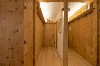 a hallway with wooden walls and wooden flooring at Casa Betulla in Cortina dʼAmpezzo