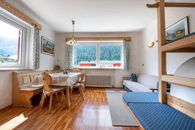 a living room with a table and a bunk bed at Apartments Vintlana in Selva