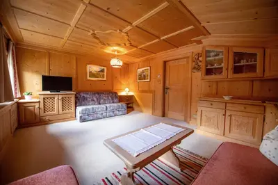 a living room with a couch and a table in a room at Apartments Vintlana in Selva