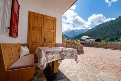 a room with a table and a table and a door at Apartments Vintlana in Selva