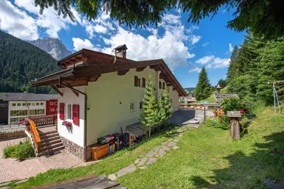 a small house in a village in the mountains at Apartments Vintlana in Selva