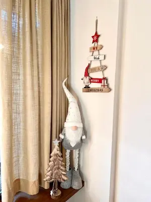 a shelf with a christmas ornament and a christmas tree at Suite AGB in Mazzin