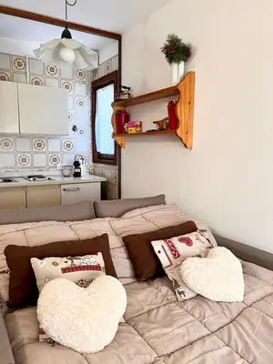 a living room with a couch with two pillows at Suite AGB in Mazzin