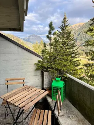 a picnic table and a green cooler on a balcony at Suite AGB in Mazzin