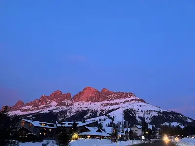 a resort in the snow with a mountain in the background at Suite AGB in Mazzin