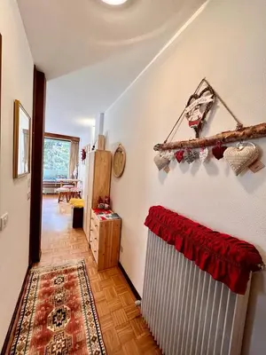 a hallway with a room with a radiator and a table at Suite AGB in Mazzin