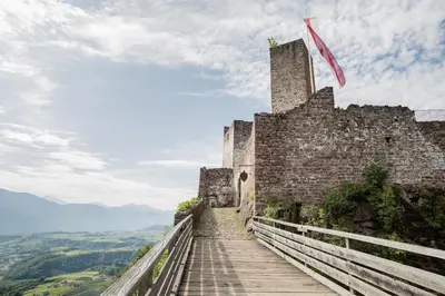 a staircase leading up to a castle on a hill at Schmitte am Sonnenwirtsplatz Eppan in South Tyrol, perfect starting point for bike and hike in Appiano sulla Strada del Vino