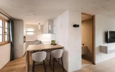a kitchen with a table and chairs in a room at Schmitte am Sonnenwirtsplatz Eppan in South Tyrol, perfect starting point for bike and hike in Appiano sulla Strada del Vino
