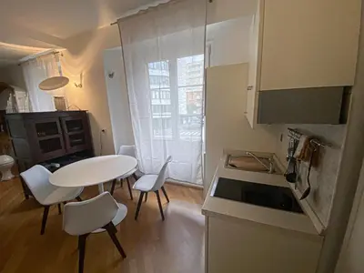 a small kitchen with a table and chairs in a room at Living Vittoria: vicino al Centro di Bolzano in Bolzano