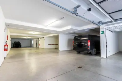an empty garage with a van parked in it at Alpine View Plan de Corones in Sorafurcia