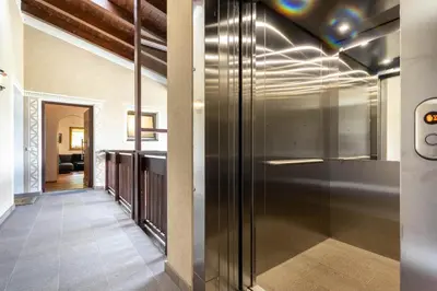 a hallway with a glass door leading to a kitchen at Alpine View Plan de Corones in Sorafurcia