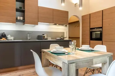 a kitchen and dining room with a wooden table and chairs at Alpine View Plan de Corones in Sorafurcia