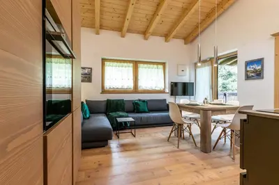 a living room with a couch and a table at Alpine View Plan de Corones in Sorafurcia