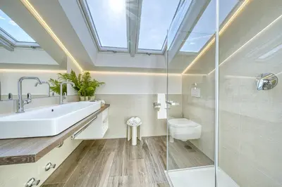 a skylight in a bathroom with a sink and a toilet at Appartements Kreuzwegerhof in Lana