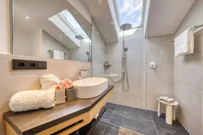 a bathroom with a sink and a shower at Appartements Kreuzwegerhof in Lana