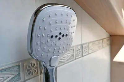 a shower head on a wall in a room at Mansarda Le Genziane di Fiemme in Cavalese
