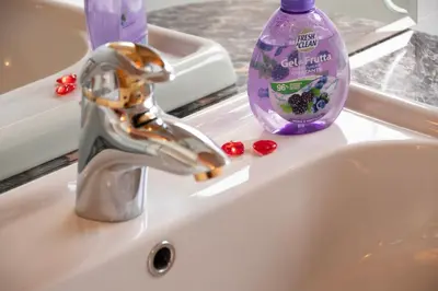 a sink with a bottle of toothpaste and a tooth paste at Mansarda Le Genziane di Fiemme in Cavalese