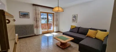 a living room with a couch and a table at Cesa Fortunato in Canazei