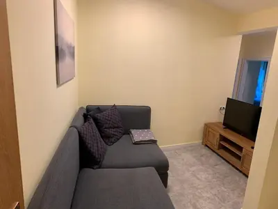 a living room with a couch and a television at Hernegg Apartment in Riscone