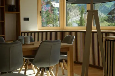 a dining room with a table and chairs and a window at Villa Vitis in Rifiano