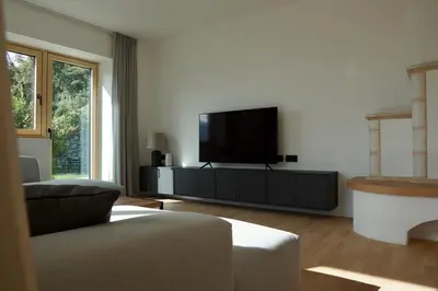 a living room with a flat screen tv on a entertainment center at Villa Vitis in Rifiano