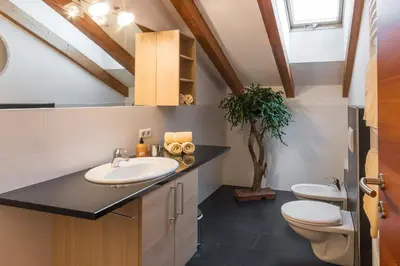 a bathroom with a sink and a toilet at Haus Alpenjuval in Fundres