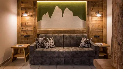 a living room with a couch and two tables at Haus Alpenjuval in Fundres