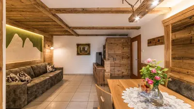 a living room with a couch and a table at Haus Alpenjuval in Fundres