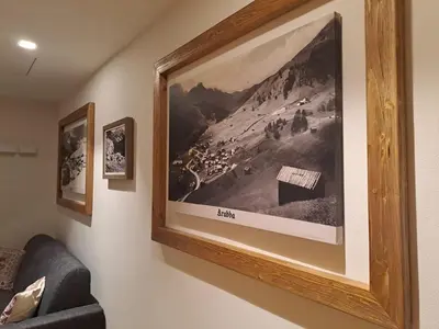 a picture of a painting hanging on a wall at Appartamento Césa Ines in Arabba