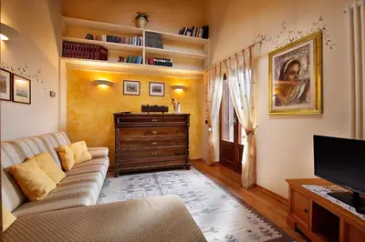 a living room with a couch and a tv at Hotel Leonardo in Moena