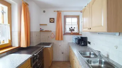 a small kitchen with a sink and a window at Ferienwohnung Maiernhof Bauernhof Ultental in San Pancrazio dʼUltimo