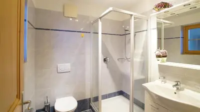 a bathroom with a shower and a toilet and a sink at Ferienwohnung Maiernhof Bauernhof Ultental in San Pancrazio dʼUltimo