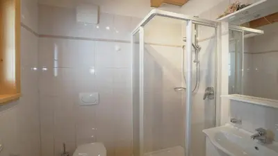 a bathroom with a shower and a toilet and a sink at Ferienwohnung Maiernhof Bauernhof Ultental in San Pancrazio dʼUltimo