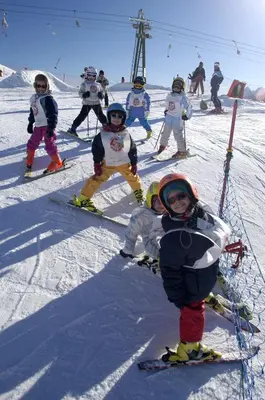 a group of children on skis on a ski slope at Residence Molin in Rocca Pietore