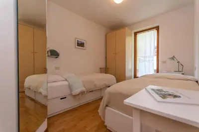 a bedroom with two beds and a window at Maison Villagrande in Colle Santa Lucia