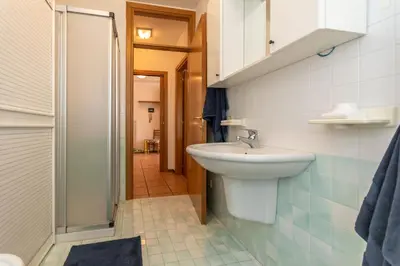 a bathroom with a sink and a shower at Maison Villagrande in Colle Santa Lucia