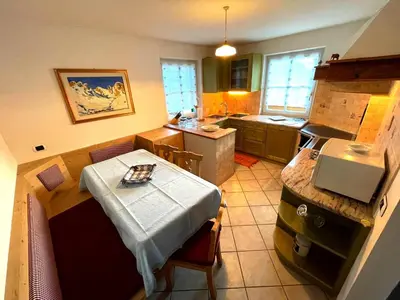 a small kitchen with a table and a counter top at Ciasa Rossi in Soraga