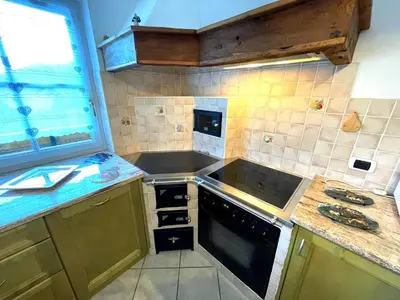 a kitchen with a sink and a stove top oven at Ciasa Rossi in Soraga