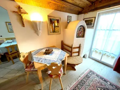 a room with a table with a cat sitting on it at Ciasa Rossi in Soraga