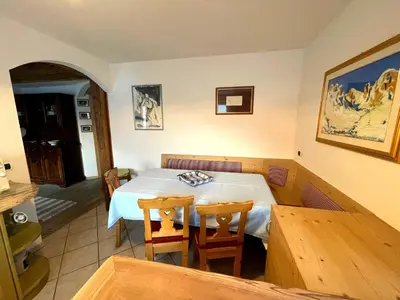 a dining room with a table and two chairs at Ciasa Rossi in Soraga