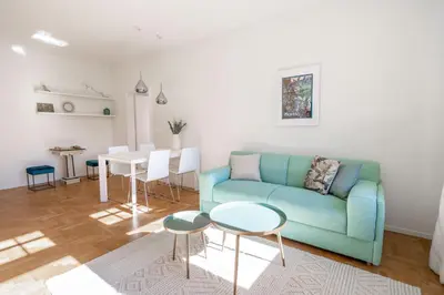 a living room with a blue couch and a table at Italyescapes Emma 11 in Merano