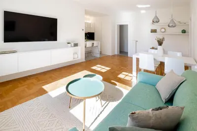 a living room with a blue couch and a table at Italyescapes Emma 11 in Merano