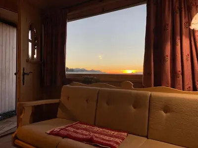 a living room with a table and a couch at Cozy Mountain Chalet in Cavalese