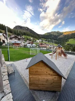 a small wooden building sitting on top of a playground at Tabia studio - Colle Santa Lucia in Villagrande