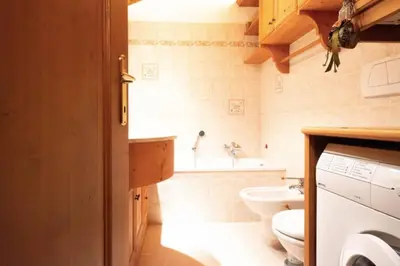 a small bathroom with a toilet and a sink at Mansarda su due livelli nel cuore delle Dolomiti in San Vito di Cadore
