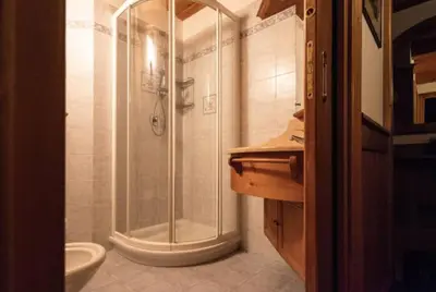 a bathroom with a shower and a toilet at Mansarda su due livelli nel cuore delle Dolomiti in San Vito di Cadore